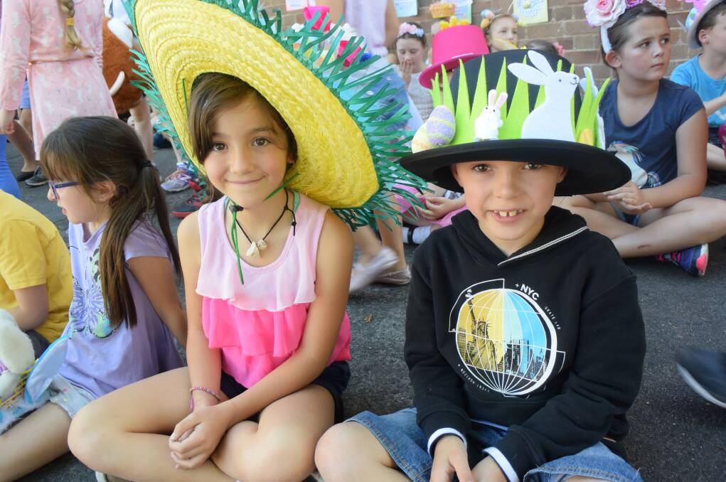 HATS WERE NEEDED: Ginjer Andrews and Brayden Phillips take part in a tradition that was very apt for the sunny weekend. Picture: KIRSTY HORTON. 