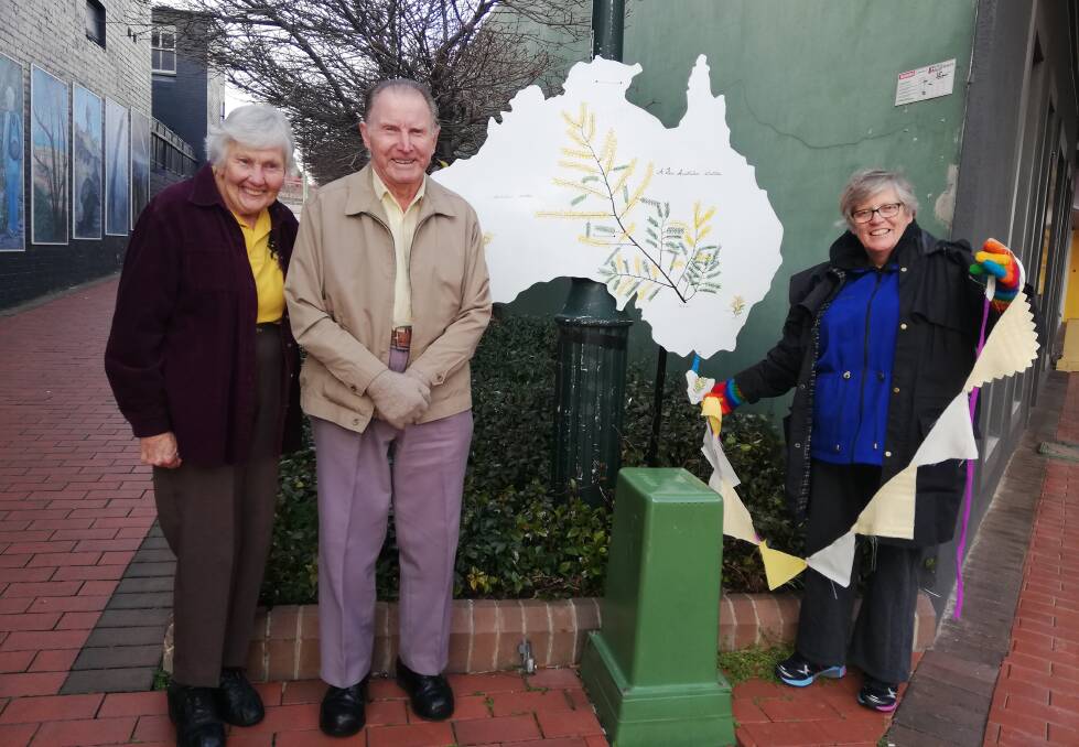 GETTING A WATTLE ON: Fay and George Quinell and Allyn Jory at Gallery Lane with their Wattle Day display. Picture: SUPPLIED.