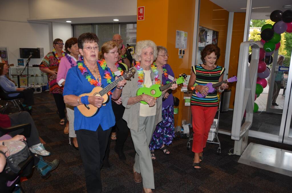 IN THE LIBRARY: Lithgow Library's Uke'n'Sing Group regales the newly refurbished library with a song especially composed for the occasion. Picture: PHOEBE MOLONEY