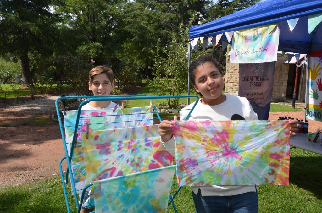 Luca Zappia and Angelina Costa participate in Subliminal's 'What makes me happy' exhibition tie-dyeing activity.