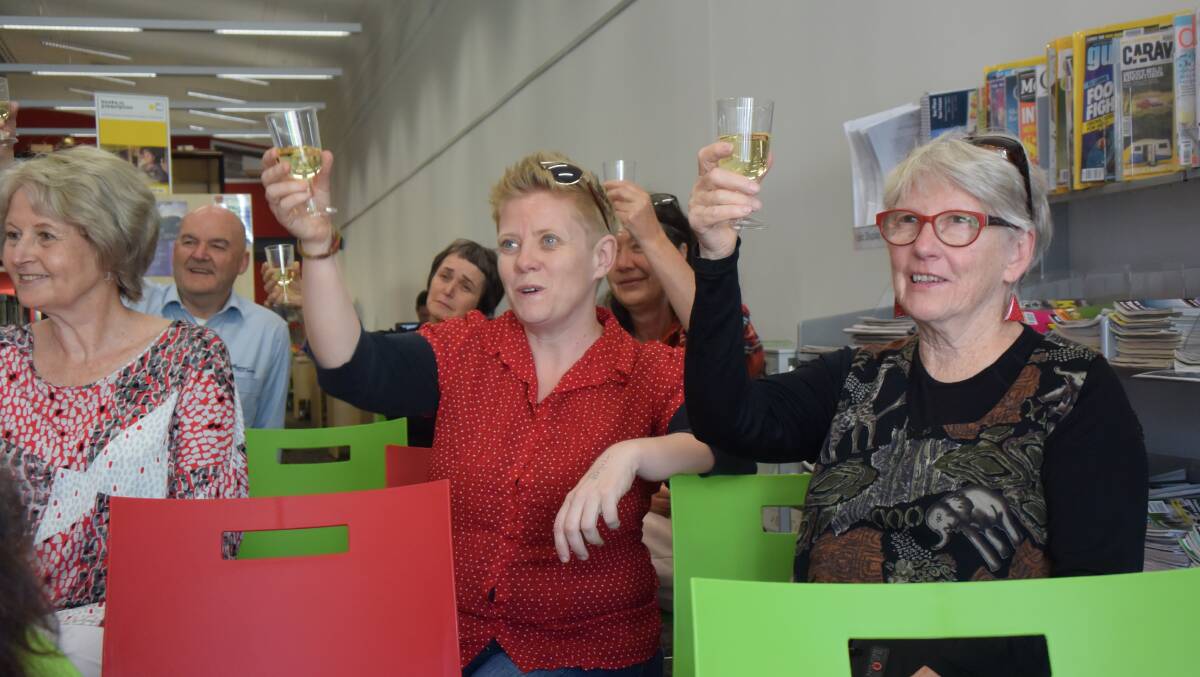 CHEERS: The audience at the library raised their glasses. Picture: PHOEBE MOLONEY. 