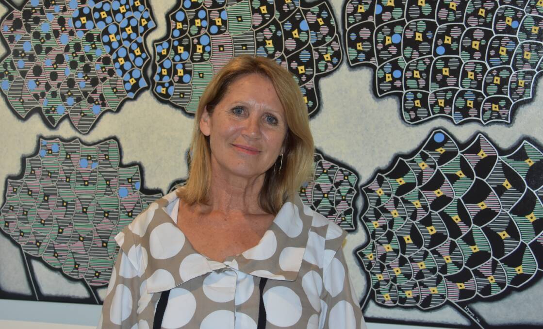 STARTING A STORY: Gang Gang Gallery owner and director Sharon Howard, with painting by Nadege Lamy. Picture: PHOEBE MOLONEY