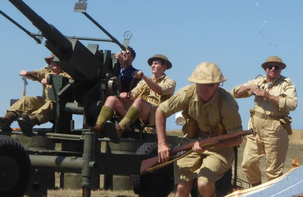 THE PLANES: Ian Rufus (fair right) with Lithgow Living History's anti-airforce gun. Picture: Lithgow Living History.