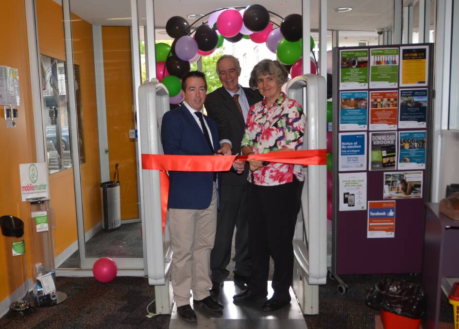 GRAND OPENING: Member for Bathurst Paul Toole, Lithgow mayor Stephen Lesslie and Ellen Forsyth from the State Library of NSW officially opening the refurbished library early last year. Picture: PHOEBE MOLONEY