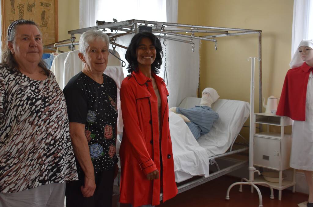 ON WARD: Sisters Anne Lennon and Fay Fulton with museum manager Premala Sangarananda in a room that recreates Portland's old hospital. Picture: PHOEBE MOLONEY