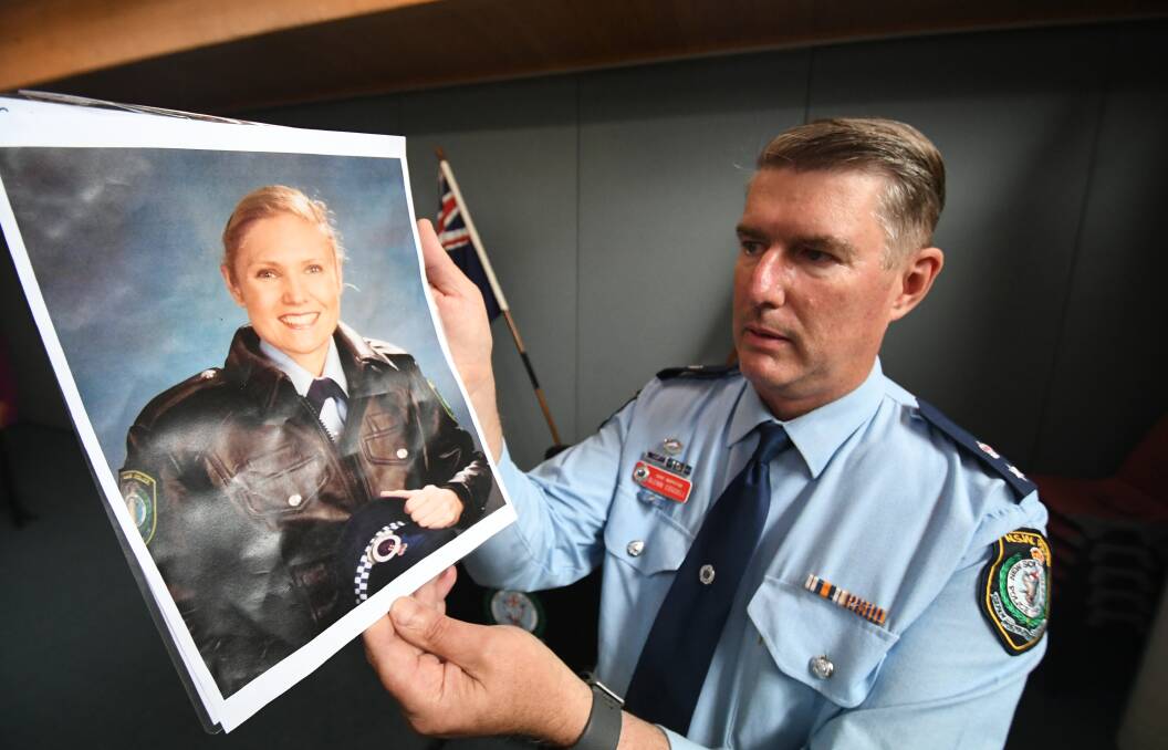 TRAGIC NEWS: Acting Superintendent Glenn Cogdell with a photo of the late Senior Constable Kelly Foster. Photo: CHRIS SEABROOK.