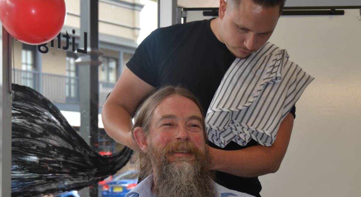 BEFORE SHOT: Tim Miller from Tough Grind prepares Lithgow librarian Mr Royall for his moustache removal and beard trim. Photo: Troy Walsh.