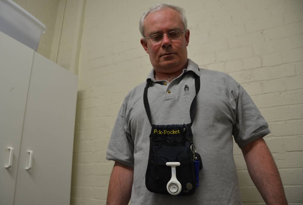 MANY CAMERA OPTIONS: Anthony Craig displays his body camera contained in the bag around his neck. A sign on the camera could indicate it was filming.