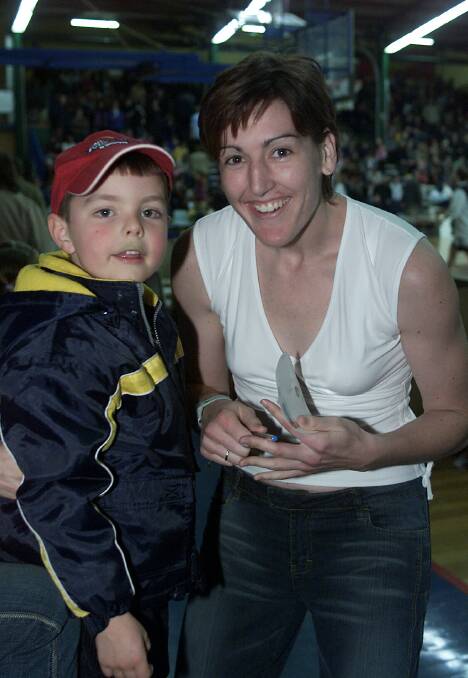 Boyd signs an autograph for a young fan at the Devonport Recreation Centre in 2003 where the Opals were playing New Zealand.