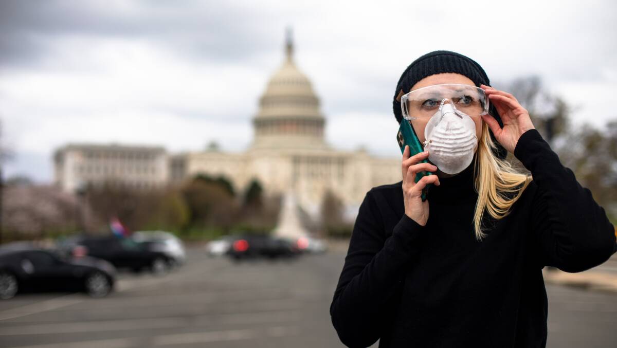 An woman in protective gear at the US Capitol building in Washington, DC. Photo: Shutterstock