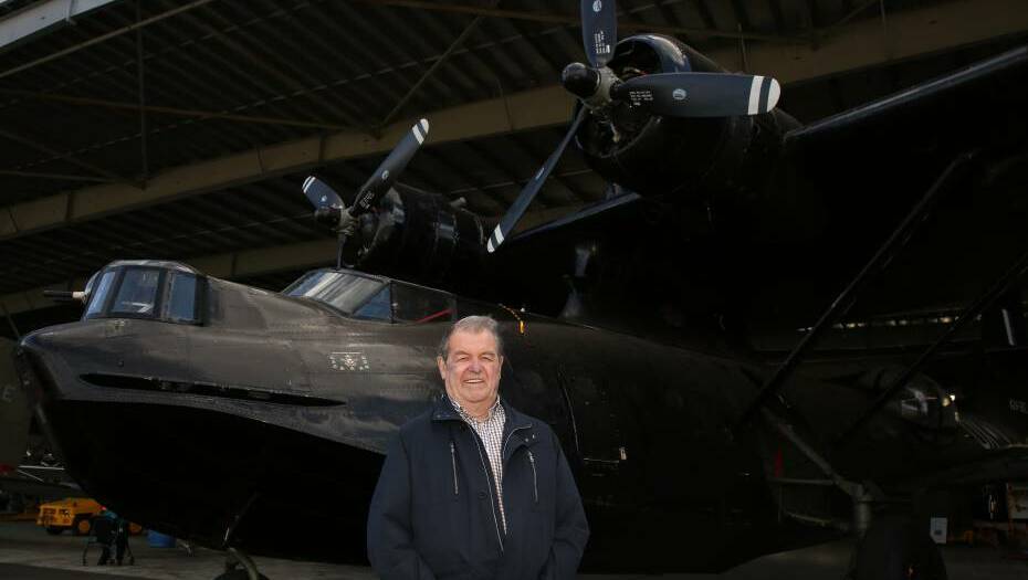 Mystery solved: John Walter Bissett-Amess, of Mount Warrigal, with the Catalina at HARS which is similar to the one his uncle was on board with nine other crew when it crashed in Irian Jaya. Picture: Greg Ellis.