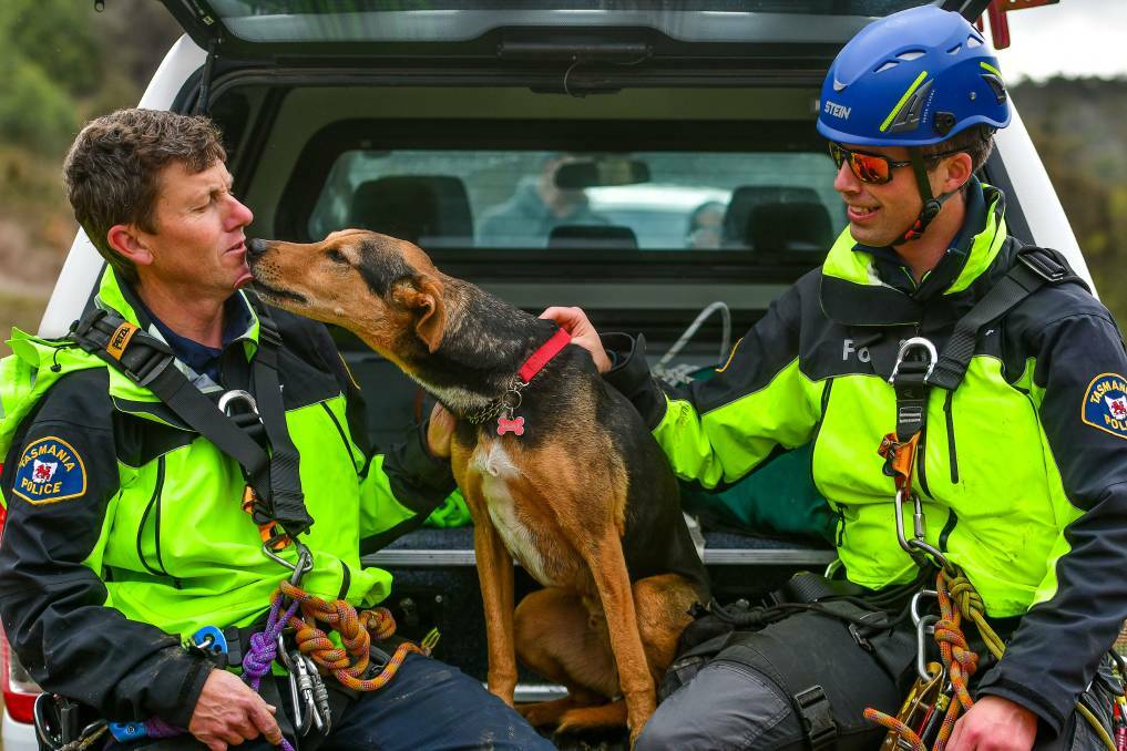 Ralphie (middle) thanks Senior Constables Simon Triffitt and Leighton Riggall for rescuing him from a cliff face. Picture: Scott Gelston 