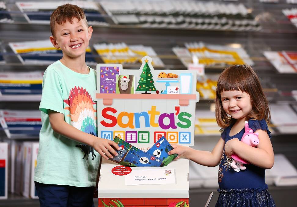 Flynn and Lillia post their Christmas wish lists to Santa.