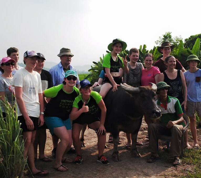 SKILLS: At an eco adventure site students learned to fill a rice paddy with water, plant rice, ride bikes: and a water buffalo! 