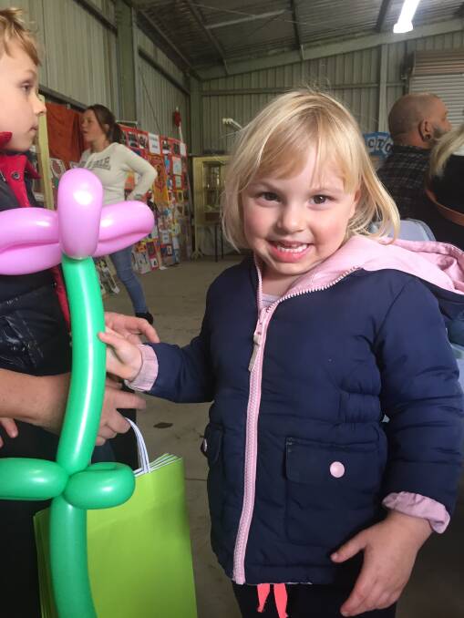 FULL OF FUN: There will be plenty to see, do and enjoy for youngsters at this year's show. Last year Nyah Allen was thrilled with her balloon flower.
