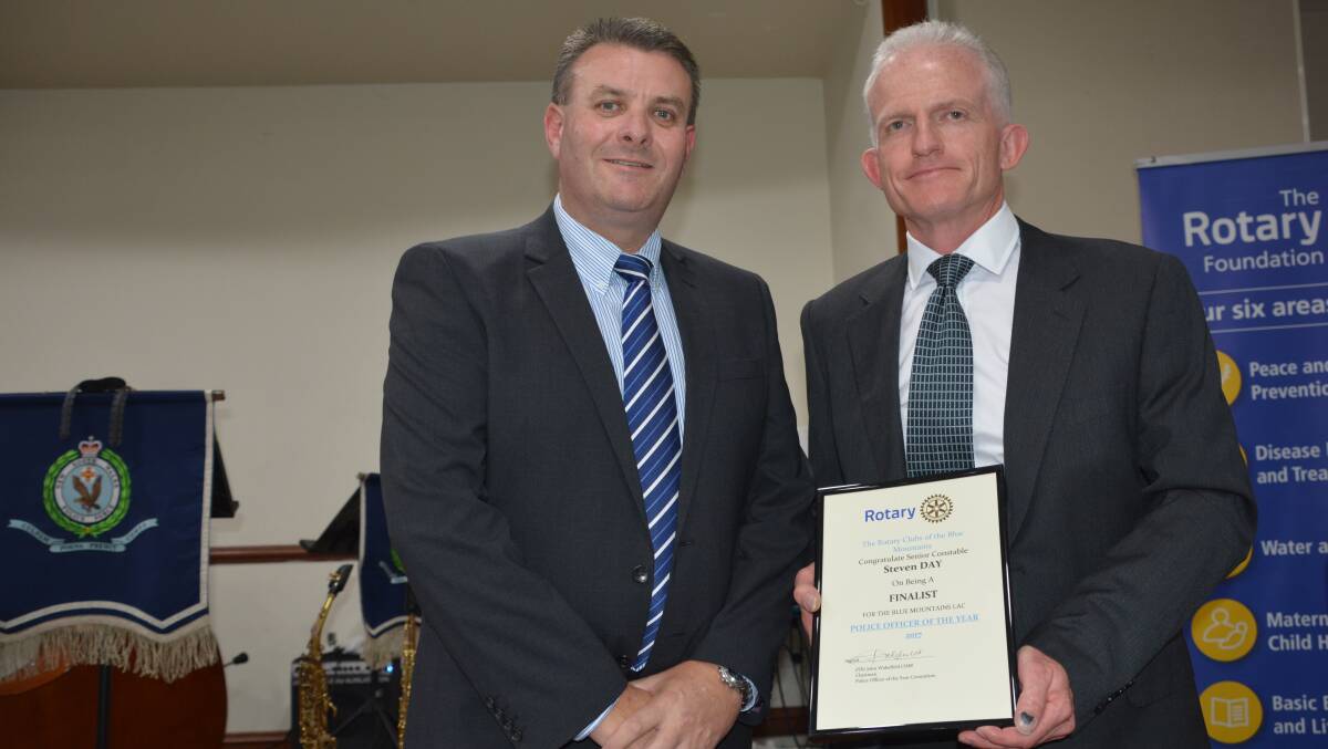 Former Blue Mountains Police Commander Superintendent Darryl Jobson presents Senior Constable Steven Day with his Blue Mountains Police Officer of the Year award in April.