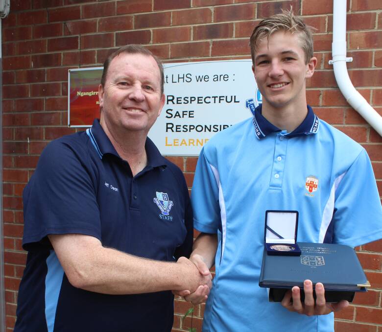 CHAMPION: Lithgow High School deputy principal Mr Dean presenting year 12 student Logan Hunter with his NSW Combined High Schools Sports Association Blue Award for hockey. Picture: SUPPLIED