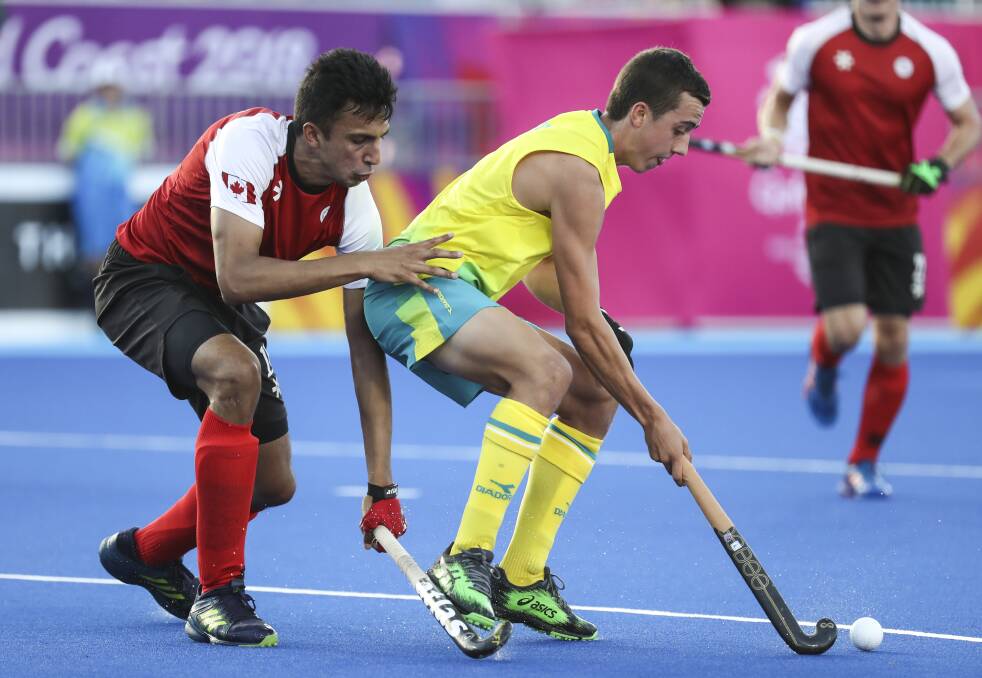Lachi Sharp takes on the Canada defence during their Pool B game on Tuesday. Photo: Hockey Australia/Grant Treeby