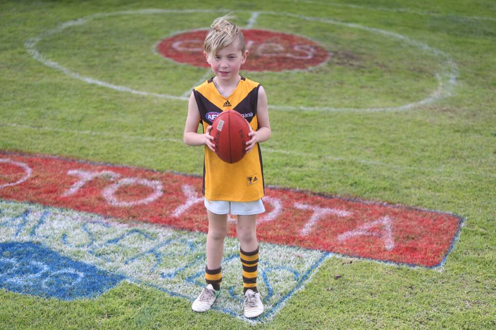 HAVING A BALL: Warrnambool's Lawson Chow, 7, loves playing games on his AFL-inspired football oval. He used his pocket money to buy spray paint to maintain the ground throughout the season. Picture: Mark Witte 