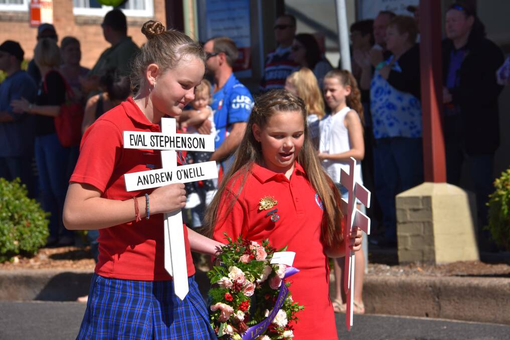 Lest We Forget: Elsey Cavill Low and Nikera Hann from Portland Central School prepare to lay crosses during the Anzac Day March. Photo: Phoebe Moloney.
