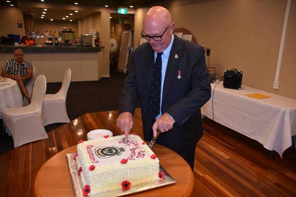 Celebrating a century: Portland RSL President, Norman Richardson, cutting the cake at their 100th anniversary. Photo: File.