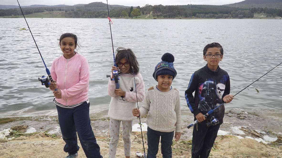 Hoping for a bite: Jaazba, Baasil, Salmana and Sadaaqat Mahmood all took the chance to reel in a big one at the 2018 Gone Fishing Day. Photo: Supplied.