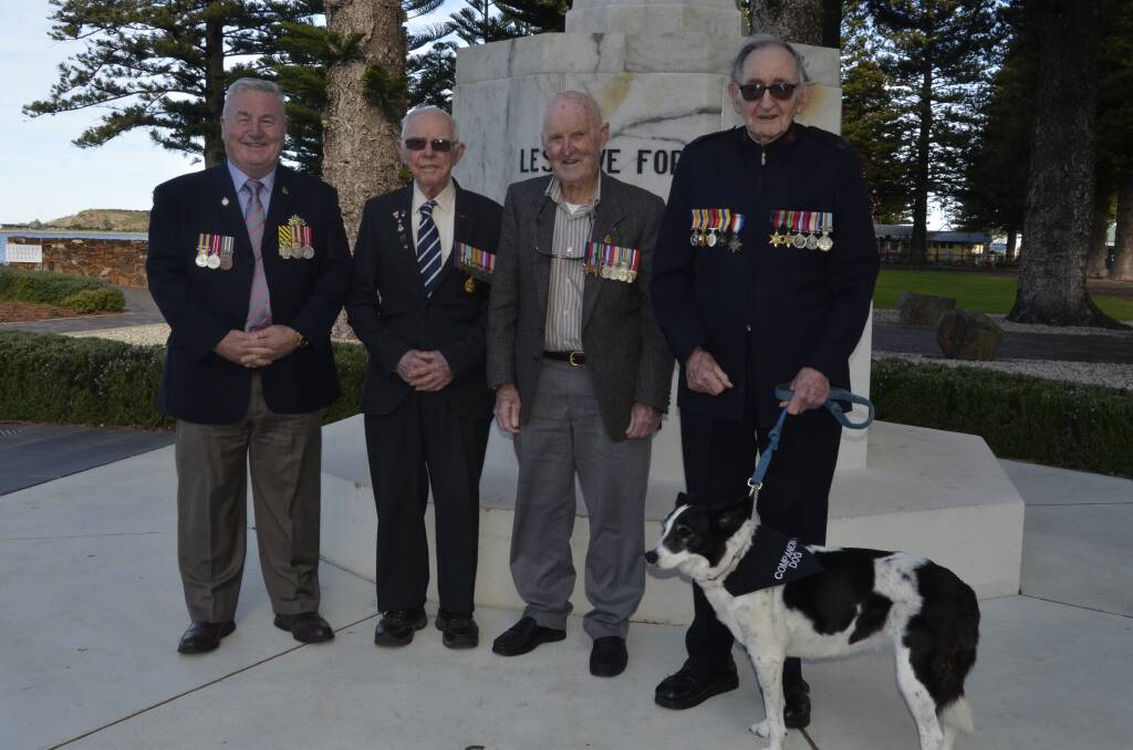 AT THE CROSS: Acting President of the Victor Harbor RSL Kent Johncock with WW2 veterans Norman Ginn, Don Bartel and Laurence Jennings with his carer dog Bailey Potts.