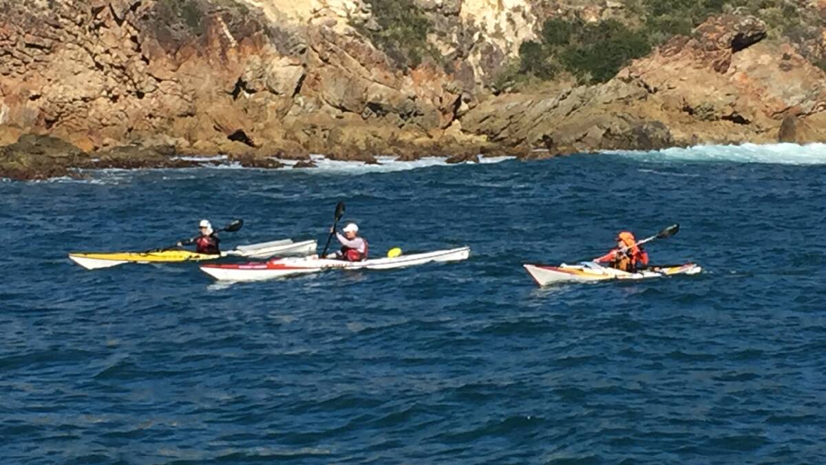 Sea kayakers paddling into Esmeralda Cove to camp on Broughton Island. 