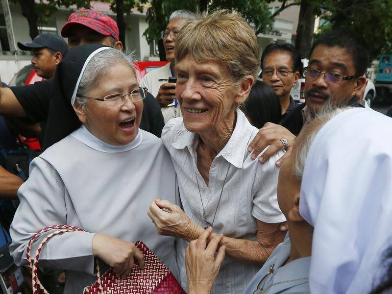 The Philippines government has ordered that Sister Patricia Fox (C) be deported and blacklisted.
