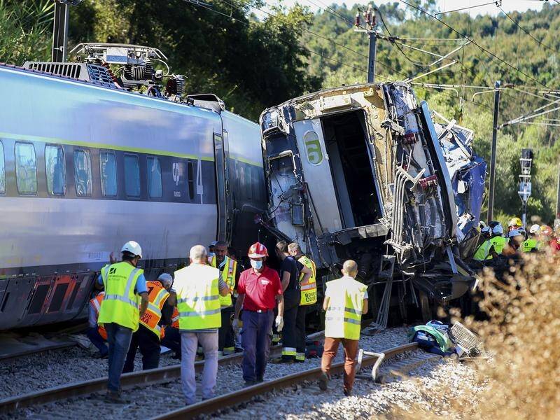 Two rail workers have been killed in Portugal after a train crashed into a maintenance machine.