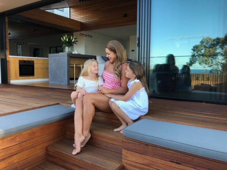 Rozetta Naumoski, owner of the landmark floating house at Burleigh Heads, relaxing at home with daughters Mia (left) and Sienna..