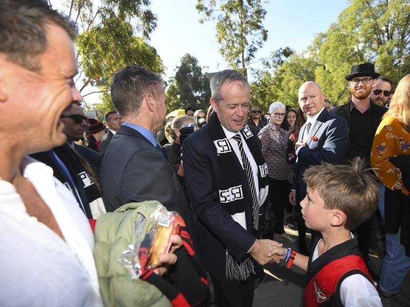 Labor leader Bill Shorten speaks to a young fan before the Collingwood-Essendon game on Anzac Day.