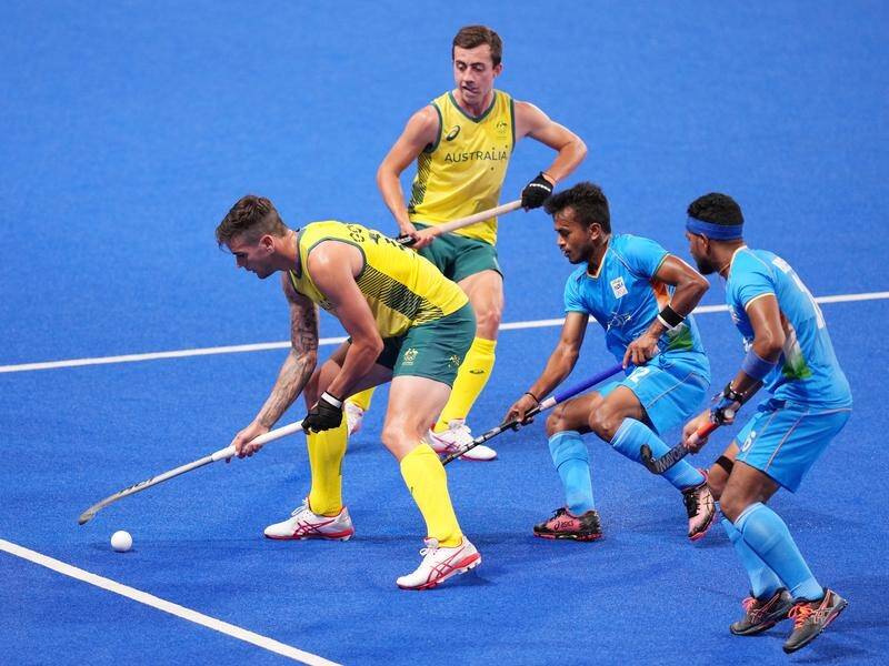 VICTORY: Lachi Sarp (back) made his Olympic debut with Australia running riot against India, winning 7-1 to stay unbeaten in men's hockey.