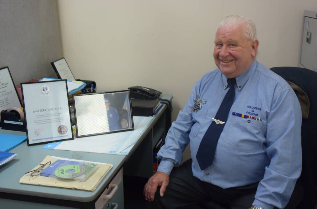 TWENTY YEARS OF SERVICE: John Barlow OAM at his desk in the Lithgow Police Station with an award of recognition of his service to NSW Police. Picture: PHOEBE MOLONEY. 