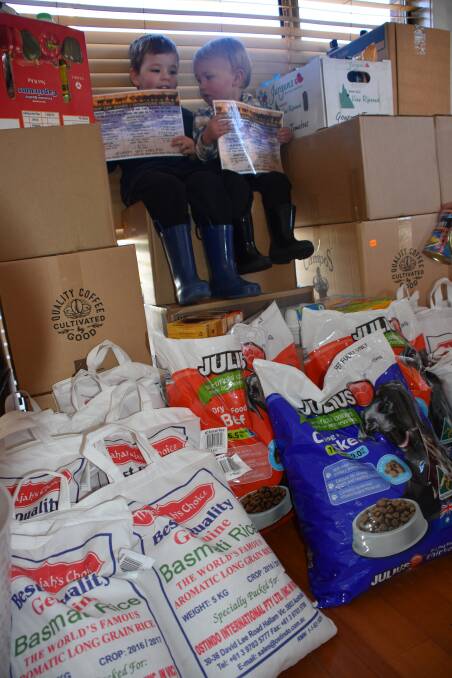 HELPING OUT: Ollie Fitzgerald, 3, and Huck Phillips, 2, with some of the donations made so far. Picture: KIRSTY HORTON. 