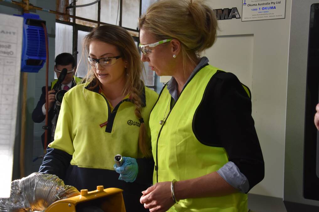 SMALL ARMS: Lithgow Arms employee Richelle Thompson demonstrates some of the production elements to Senator Bridget McKenzie. Pictures: KIRSTY HORTON. 