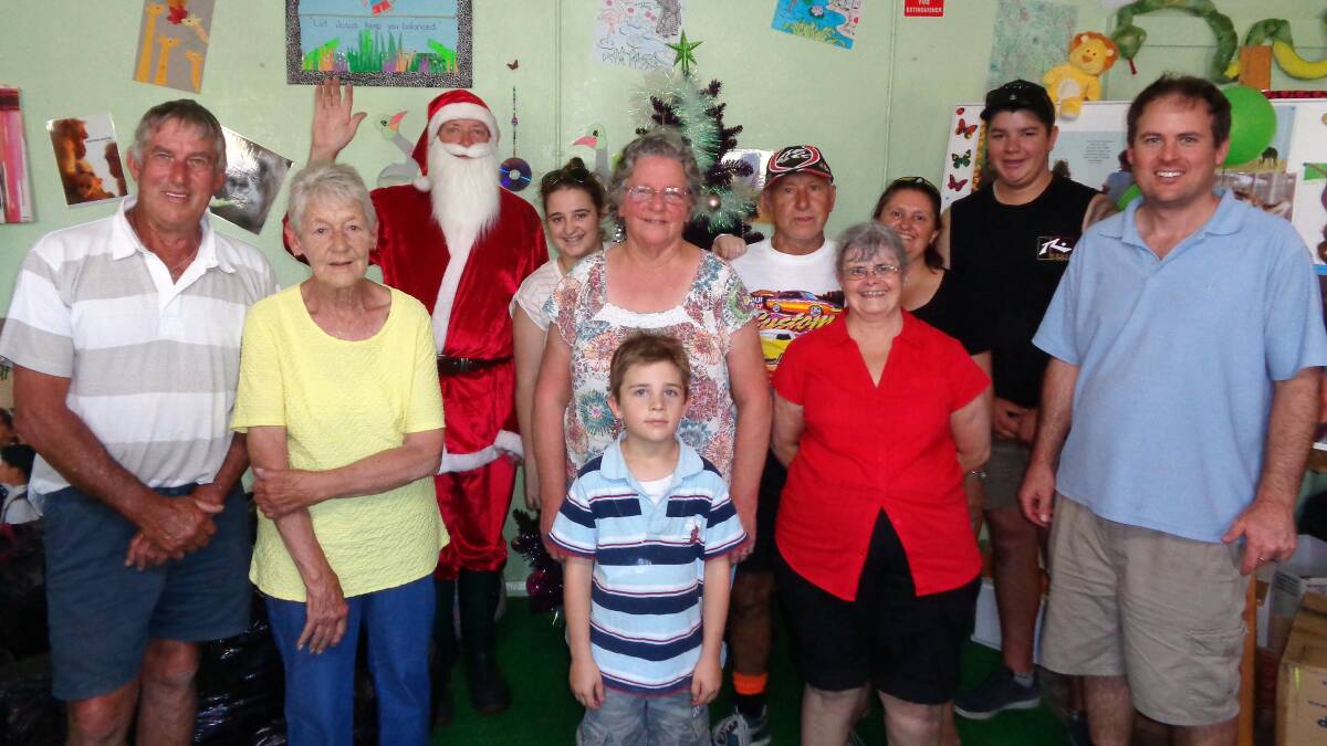 A HELPING HAND: Santa with his helpers and Marion Lamb from the Wallerawang Kids Club. Picture: DAVE MARTIN. 