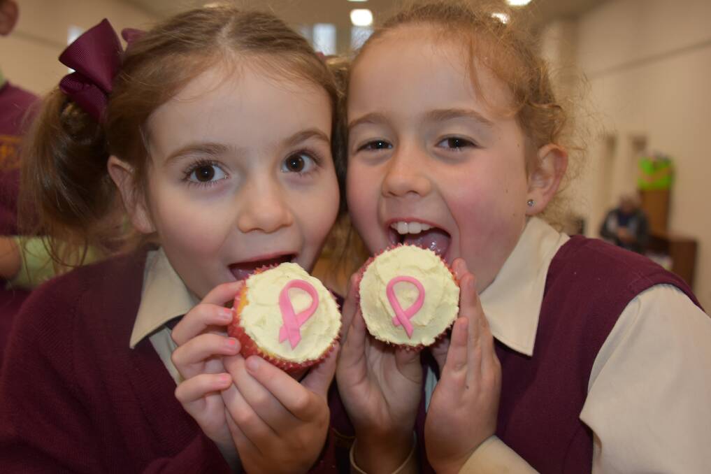 PINK RIBBON CUPCAKES: Samara Kirkland and Ruby Offner raise funds for cancer research at St Patrick's Primary School. Picture: KIRSTY HORTON. 