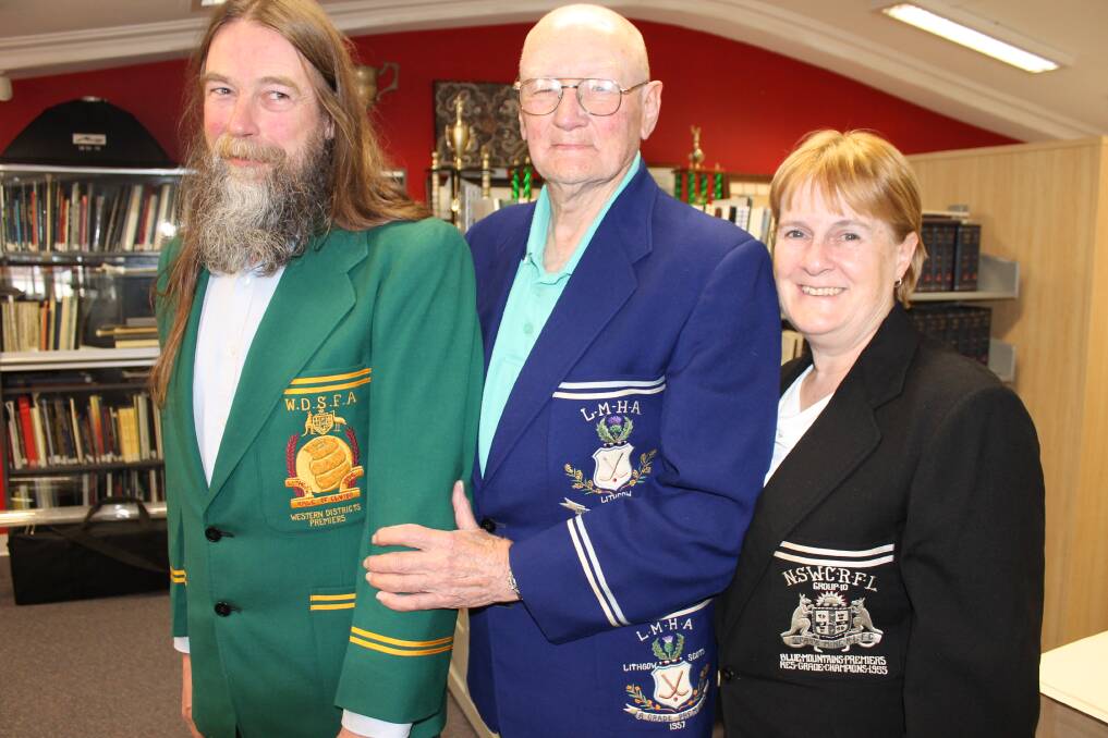 SPORTING MEMORABILIA:  Three premiership blazers from three different sporting codes in the 1950s are tried for size by acting chief librarian Sharon Lewis (State Mine RLFC blazer), veteran Lithgow sporting identity Sandy Davidson (Scots) and librarian  Bruce Royall (Vale of Clwydd).