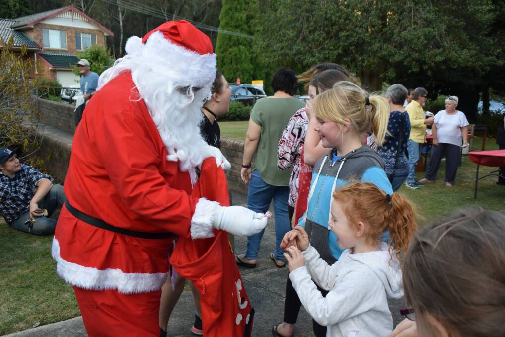 A VISIT FROM SANTA: There were lollies in Santa's bag when he called in at Zig Zag Public School on December 7, 2017. Picture: KIRSTY HORTON. 