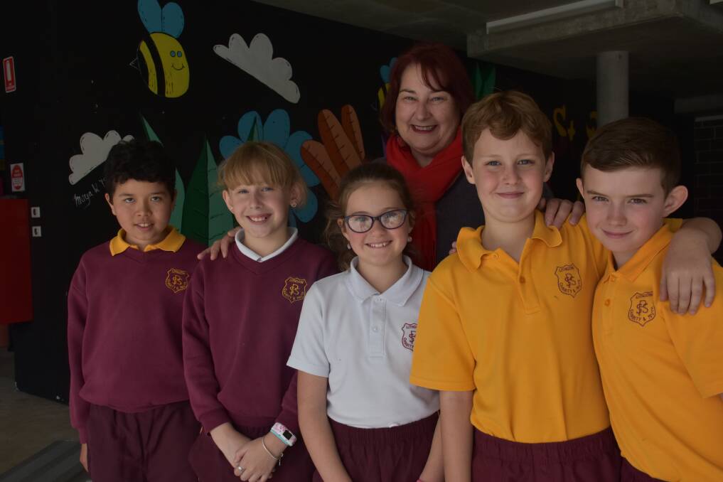 GAINS: Mrs Mulholland with Year 4 students RJ Lord, Tylanni Raso, Emily Commins, Connor Byrne and Vann Cutler in front of a new mural painted by P&F members during the school holidays. 