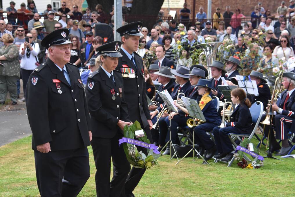 TRIBUTE: Members of the Lithgow NSW Fire and Rescue team lay a wreath at Lithgow's Anzac Day service. Picture: ALANNA TOMAZIN. 