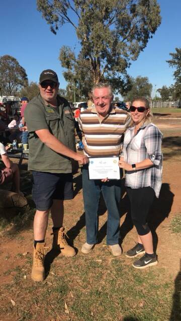 Pete Phillips and Leanne Fitzgerald receiving a appreciation certificate from Ken from the lions club.