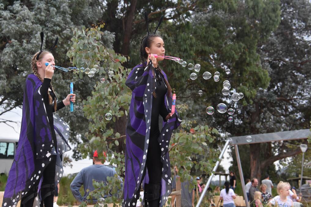 ON STILTS: Cirkus Surreal performed at the opening of the adventure playground, with musical items by Mitchell Conservatorium. Pictures: KIRSTY HORTON. 