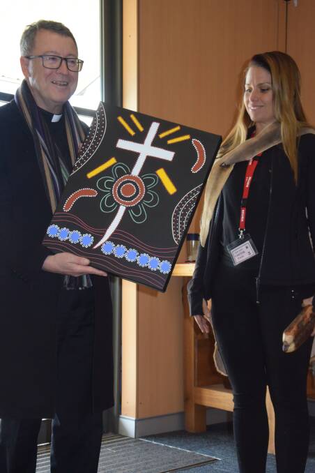 Eve White from Wandana Aboriginal Education makes a special presentation to the Bishop at the assembly at La Salle. 