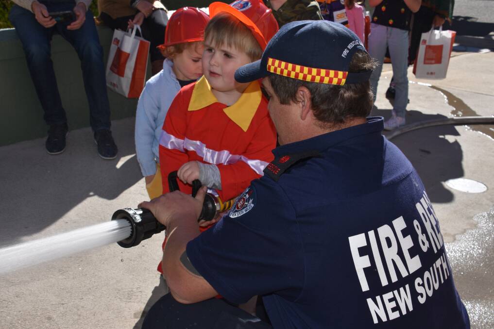 MANNING THE BIG HOSE: Junior fire-fighter Samuel Fee learning the ropes from Lithgow's Jonathan Brown at last year's open day. 