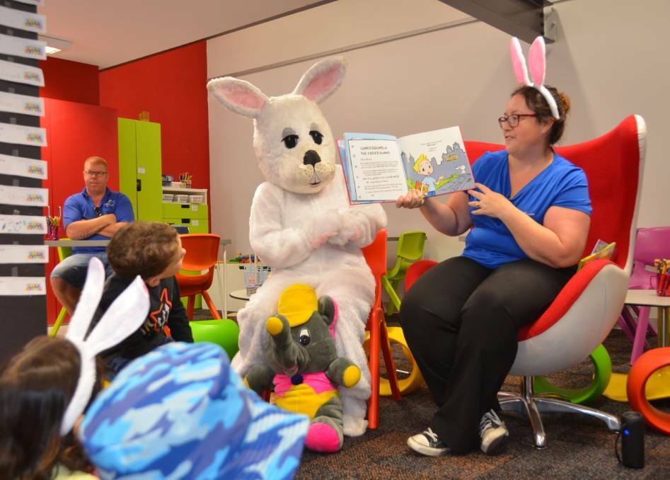 BUNNY TIME: The Easter Bunny reads along with children's librarian Kellie Drengenberg. FILE IMAGE.