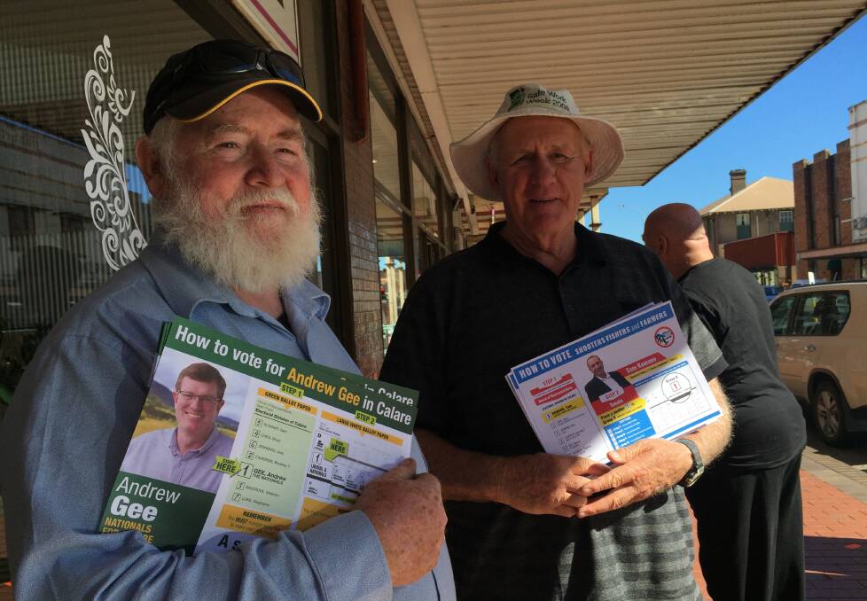 Peter Rafferty handing out for Nationals MP Andrew Gee and Ian Stewart, handing out for the Shooters, Fishers and Farmers candidate Sam Romano. 