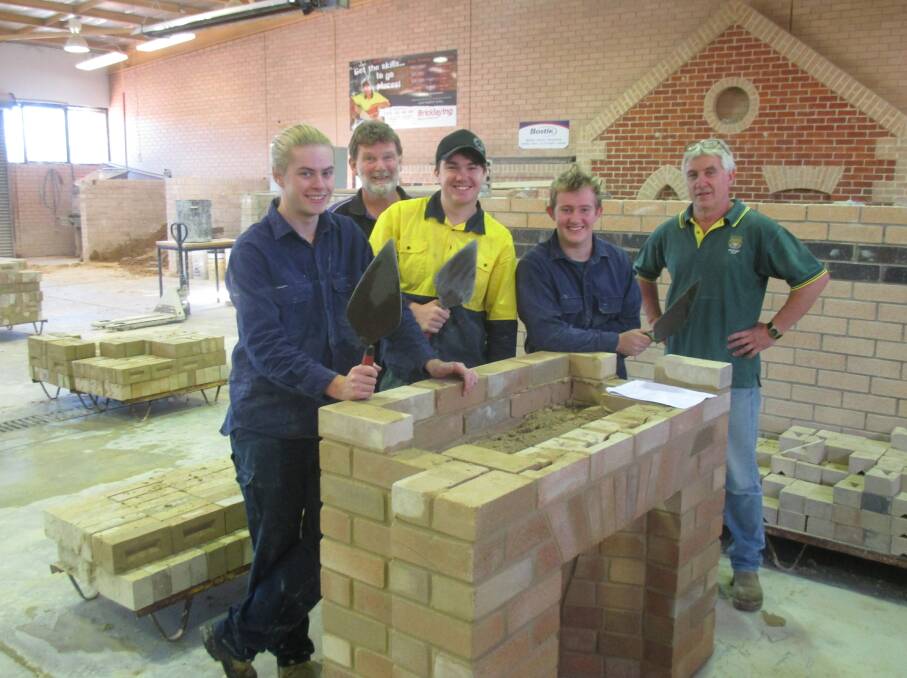 GETTING THEIR HANDS DIRTY: Students explore Bathurst TAFE's bricklaying facilities. Pictured are Brett Presbury, TAFE teacher Peter Moore, Jason Macdonald, Todd Heath and Lithgow construction teacher Wayne Morris. Picture: SUPPLIED.  ​