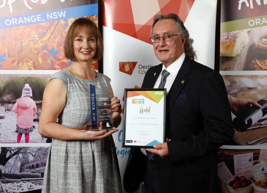 AWARD: Orange Ex-Services Club’s Graham Gentles presents the Gold award for Ecotourism to Wolgan Valley Eco Tours' Kristie Kearney. Picture: ANDREW MURRAY.
